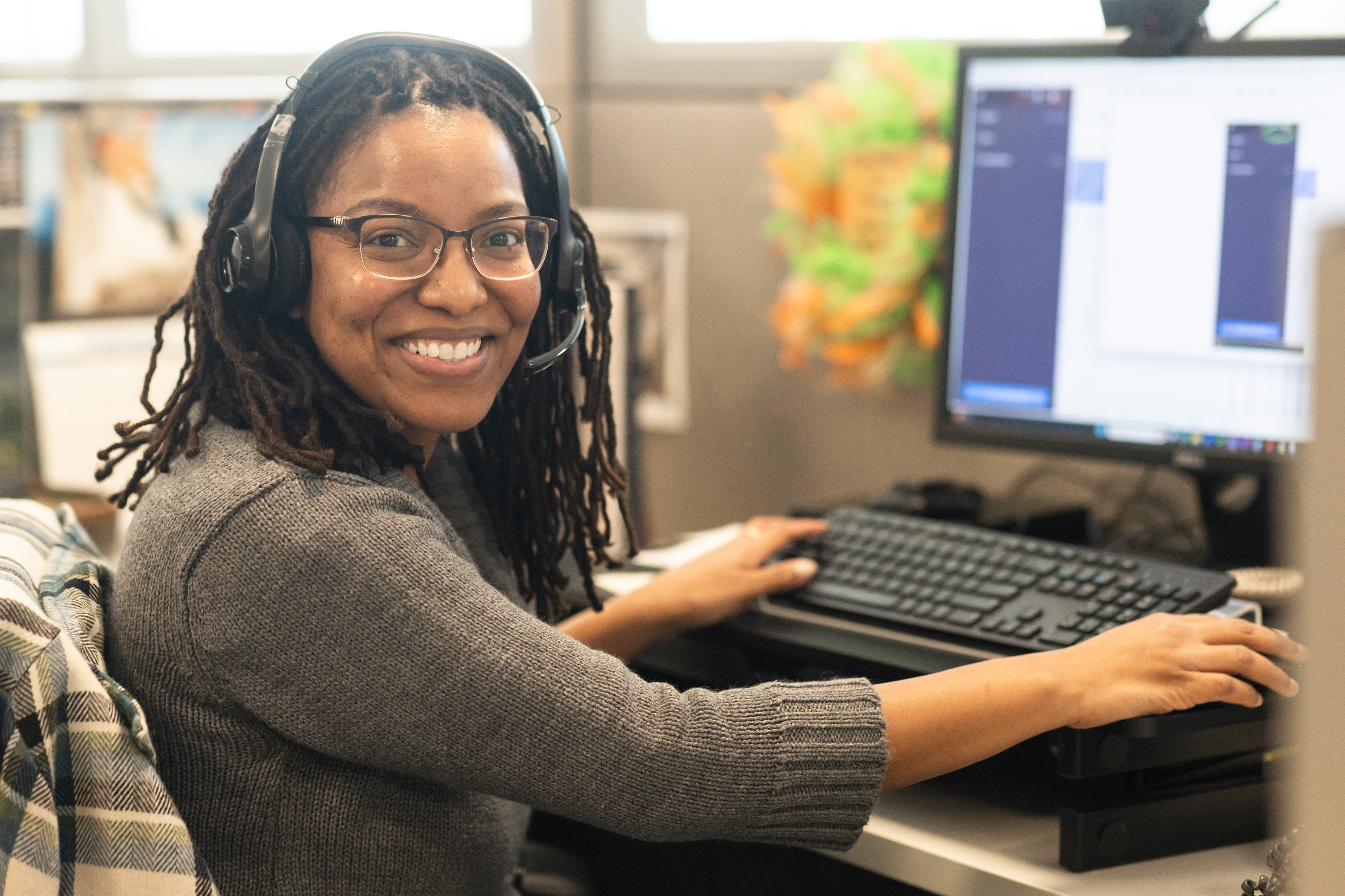 smiling woman working at a computer